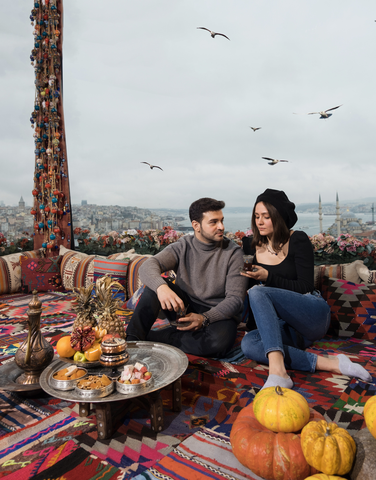 Couple Sitting on Traditional Turkish Restaurant with Food